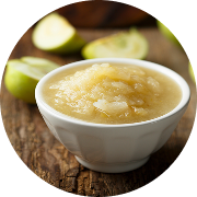 A bowl of applesauce sits on a table
