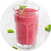 A pink fruit smoothie in a glass cup A pink fruit smoothie in a glass cup