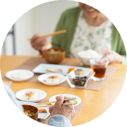 Two people with chopsticks share a meal at a dining table. Two people with chopsticks share a meal at a dining table.