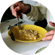 A person eats a meal from a yellow plate. A person eats a meal from a yellow plate.