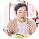 A woman with glasses eats a salad A woman with glasses eats a salad