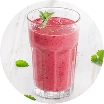 A pink fruit smoothie in a glass cup A pink fruit smoothie in a glass cup