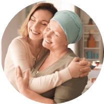 A woman and her adult daughter embrace and smile Eligibility Banner Mobile Image